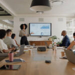 Business people, meeting and presentation on screen for data analytics, statistics and financial growth in boardroom. Professional leader, woman or analyst with monitor for graphs, charts and report