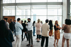 Corporate crowd showcasing teamwork and networking during a business event in a contemporary office setting. Professional and collaborative atmosphere.